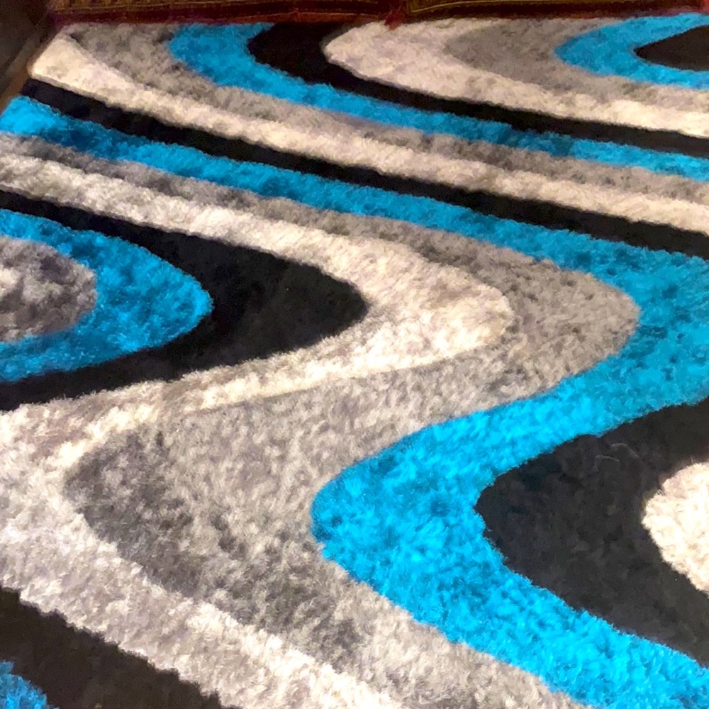 It’s a rug 9feet 2little rug with it the color is white grey and black blue.